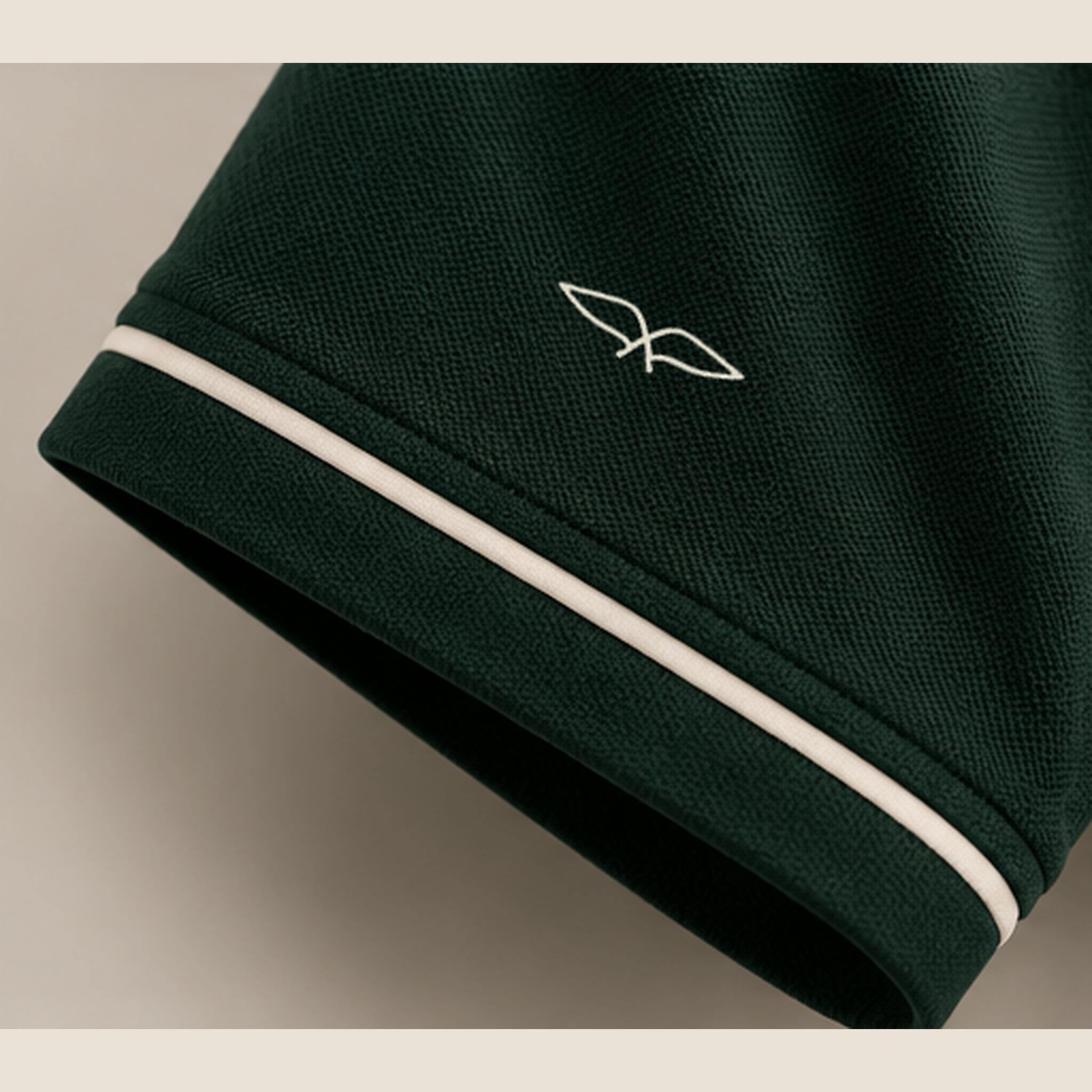 Close view of the cream sleeve piping and embroidered sparrow emblem.